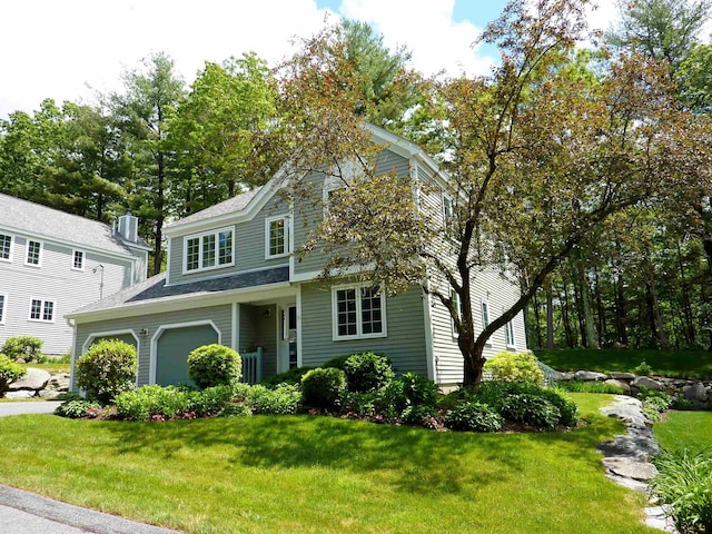 7 Lilac Ct Unit 335, Nashua, NH 03062 - view of front of house with a front yard, an attached garage, and roof with shingles