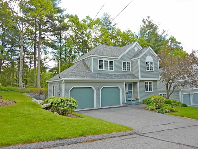 7 Lilac Ct Unit 335, Nashua, NH 03062 - traditional-style home featuring a shingled roof, asphalt driveway, a front lawn, and an attached garage