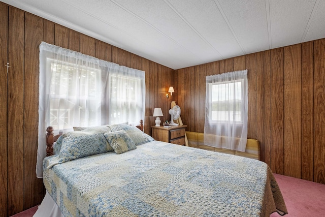 21 Pine Hill Dr, Barnstead, NH 03225 - bedroom with multiple windows, wood walls, and carpet flooring
