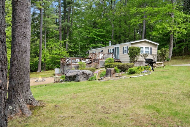 21 Pine Hill Dr, Barnstead, NH 03225 - view of front facade featuring a wooden deck, a front yard, and a view of trees