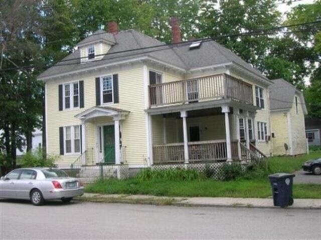 35-37 Courtland St, Nashua, NH 03060 - american foursquare style home with a balcony, a chimney, and a porch