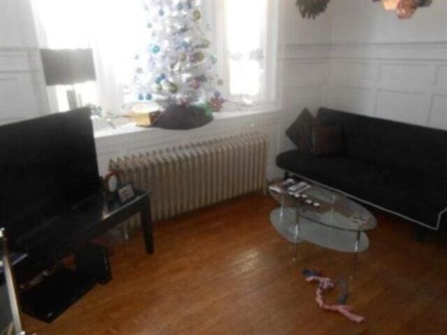 35-37 Courtland St, Nashua, NH 03060 - living area with radiator and wood finished floors