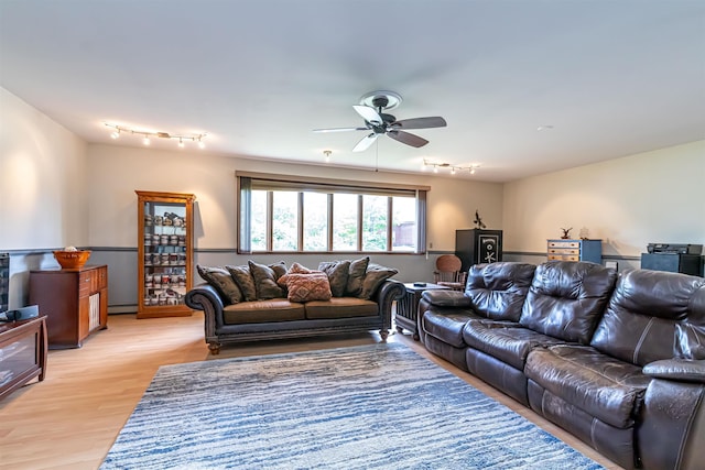 212 W Main St, Hillsborough, NH 03244 - living area with track lighting, a ceiling fan, a baseboard radiator, and light wood finished floors