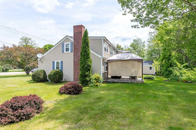 212 W Main St, Hillsborough, NH 03244 - view of side of home featuring a gazebo, a chimney, and a yard