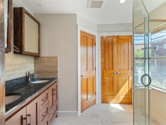 71 N Ave Unit 203, Burlington, VT 05401 - full bathroom with double vanity, decorative backsplash, baseboards, and an enclosed shower