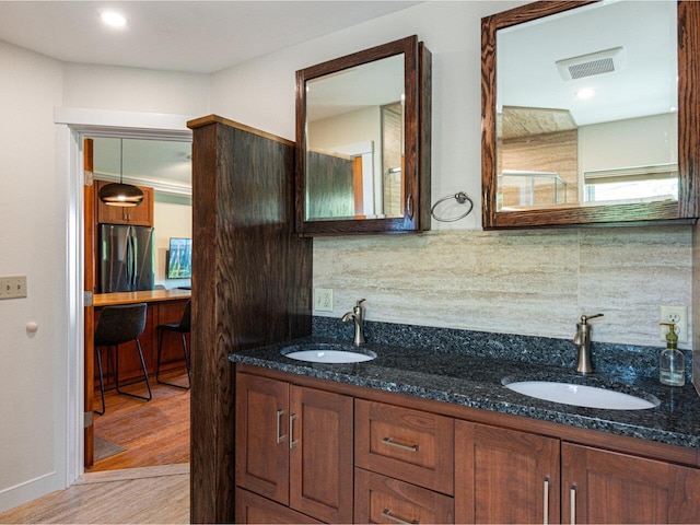 71 N Ave Unit 203, Burlington, VT 05401 - bathroom with tasteful backsplash, double vanity, wood finished floors, and baseboards