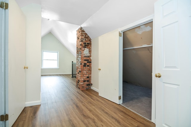 521 Wilson St, Manchester, NH 03103 - additional living space featuring wood finished floors, vaulted ceiling, and baseboards