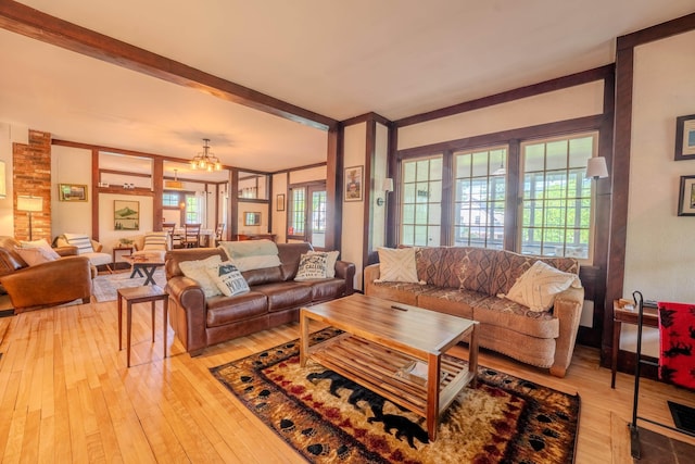 57 Main St, Woodstock, NH 03262 - living area featuring wood-type flooring, a chandelier, and beam ceiling