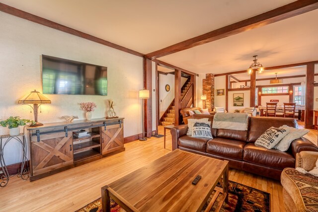 57 Main St, Woodstock, NH 03262 - living room with wood finished floors, stairway, and baseboards