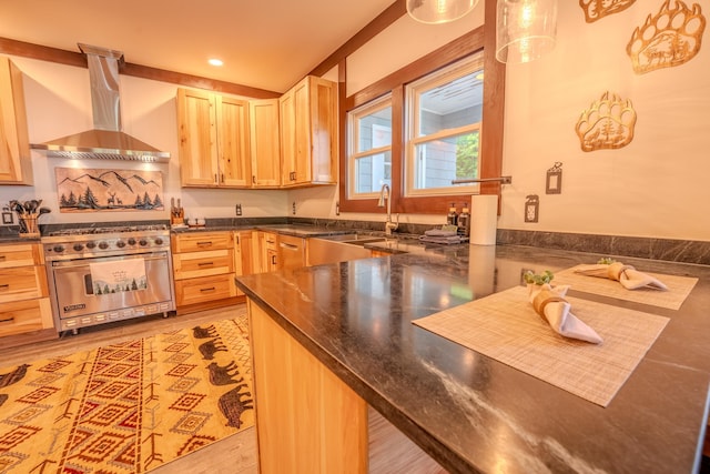 57 Main St, Woodstock, NH 03262 - kitchen featuring wall chimney range hood, luxury stove, a sink, light brown cabinetry, and recessed lighting