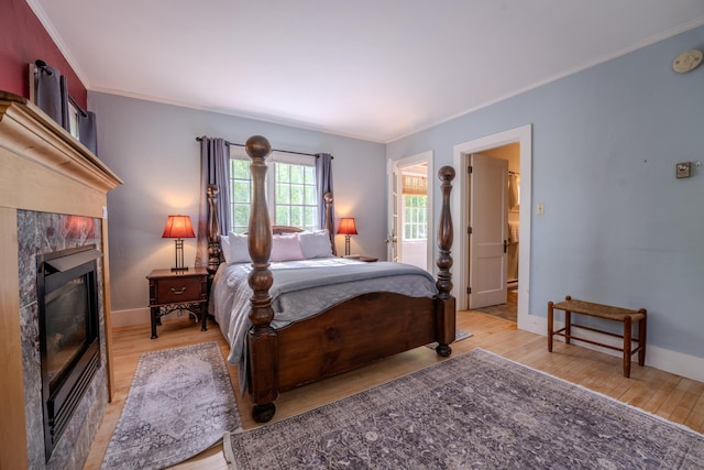 57 Main St, Woodstock, NH 03262 - bedroom with wood finished floors, a fireplace, crown molding, and baseboards