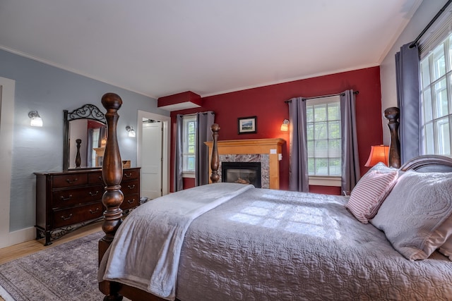 57 Main St, Woodstock, NH 03262 - bedroom featuring wood finished floors, ornamental molding, baseboards, and a fireplace