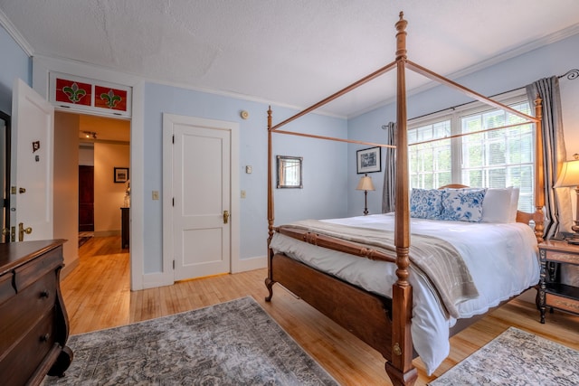 57 Main St, Woodstock, NH 03262 - bedroom with ornamental molding, wood finished floors, multiple windows, and a textured ceiling