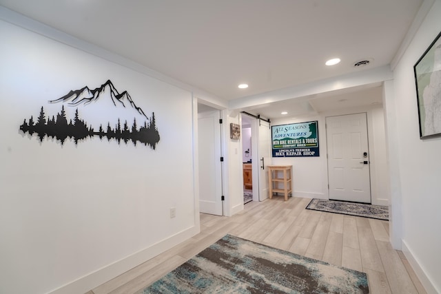 57 Main St, Woodstock, NH 03262 - entrance foyer featuring a barn door, wood finished floors, baseboards, and recessed lighting