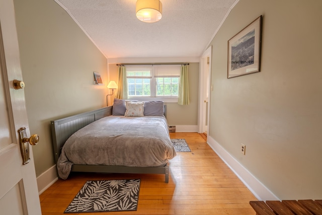57 Main St, Woodstock, NH 03262 - bedroom with crown molding, a textured ceiling, light wood finished floors, baseboard heating, and baseboards