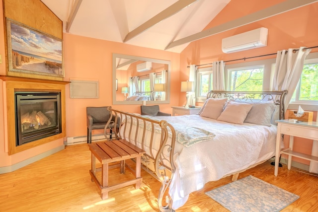 57 Main St, Woodstock, NH 03262 - bedroom with an AC wall unit, vaulted ceiling, a glass covered fireplace, wood finished floors, and a baseboard heating unit