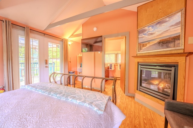 57 Main St, Woodstock, NH 03262 - bedroom featuring access to outside, light wood finished floors, lofted ceiling, french doors, and a glass covered fireplace