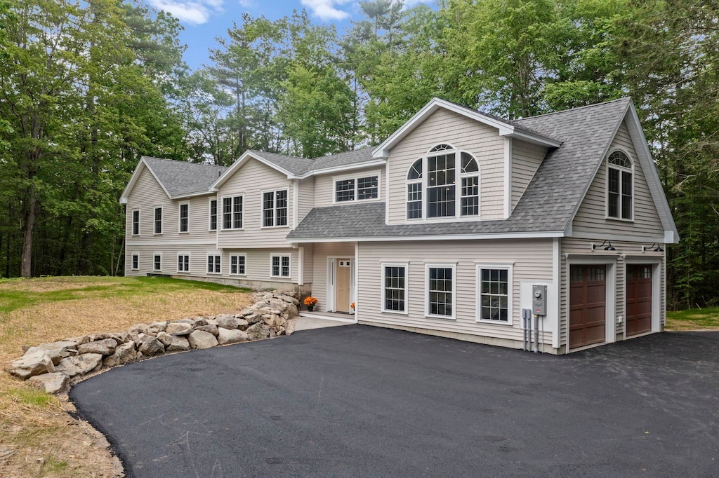 174 Brentwood Rd, Exeter, NH 03833 - view of front facade featuring asphalt driveway, roof with shingles, and an attached garage