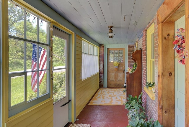 398 N Rd, Milton, VT 05468 - entryway featuring wood walls and brick wall