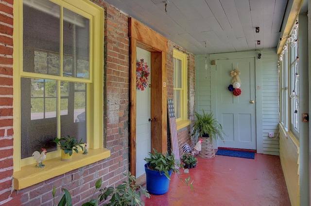398 N Rd, Milton, VT 05468 - doorway to property with brick siding and covered porch