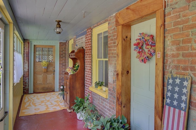 398 N Rd, Milton, VT 05468 - doorway to property featuring brick siding and a porch