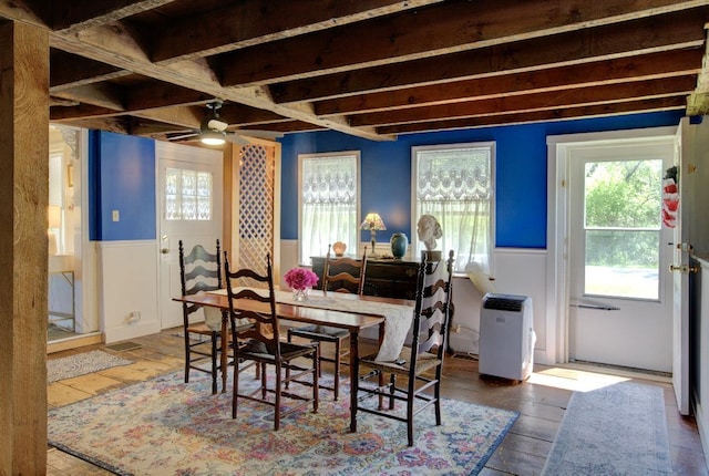 398 N Rd, Milton, VT 05468 - dining space with wainscoting, plenty of natural light, a ceiling fan, and hardwood / wood-style floors