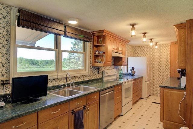 398 N Rd, Milton, VT 05468 - kitchen featuring white appliances, a sink, under cabinet range hood, wallpapered walls, and healthy amount of natural light