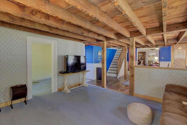 398 N Rd, Milton, VT 05468 - carpeted living area featuring wooden ceiling with exposed beams, wallpapered walls, stairway, and baseboards