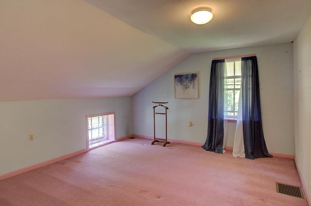398 N Rd, Milton, VT 05468 - additional living space with light colored carpet, vaulted ceiling, plenty of natural light, and baseboards