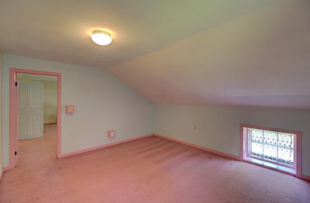398 N Rd, Milton, VT 05468 - additional living space with light carpet, vaulted ceiling, and baseboards