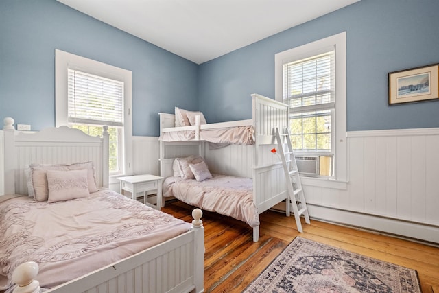 10 Wharf Rd, Center Harbor, NH 03226 - bedroom with a wainscoted wall, cooling unit, and hardwood / wood-style floors