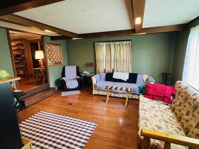 611 4-h Rd, Derby, VT 05829 - living room with beam ceiling, a textured ceiling, wood finished floors, and wood walls