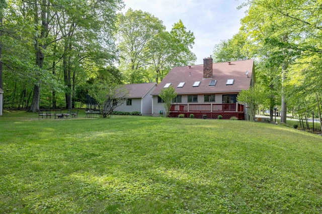 16 Berkeley St, Pelham, NH 03076 - back of property featuring a yard, a deck, and a chimney