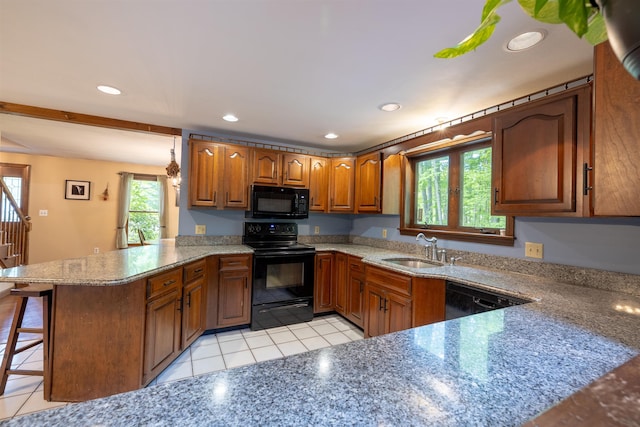 16 Berkeley St, Pelham, NH 03076 - kitchen with black appliances, a sink, a peninsula, light tile patterned flooring, and brown cabinets