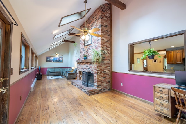 16 Berkeley St, Pelham, NH 03076 - living room with high vaulted ceiling, ceiling fan, light wood finished floors, a skylight, and beam ceiling