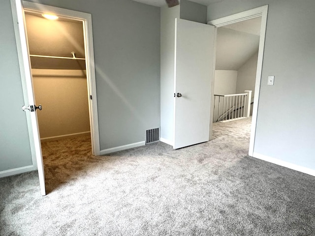 217 Clyde St, Newport City, VT 05855 - unfurnished bedroom with carpet, a spacious closet, baseboards, and vaulted ceiling