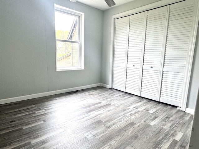 217 Clyde St, Newport City, VT 05855 - unfurnished bedroom with wood finished floors, a closet, and baseboards