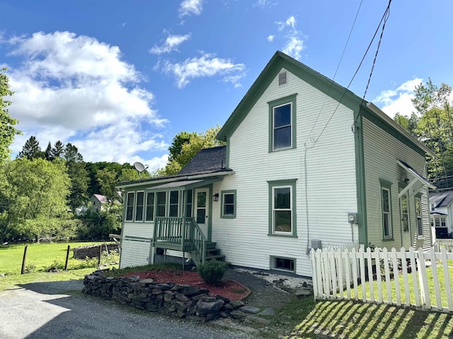 217 Clyde St, Newport City, VT 05855 - back of house featuring a sunroom and roof with shingles