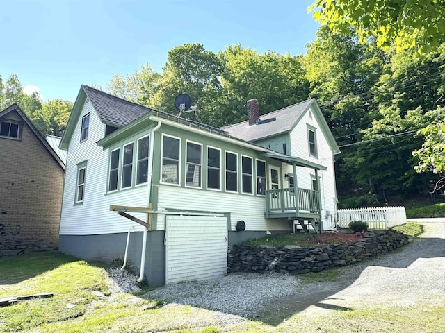 217 Clyde St, Newport City, VT 05855 - view of property exterior featuring a chimney and a shingled roof