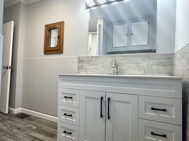 217 Clyde St, Newport City, VT 05855 - full bath with ornamental molding, vanity, wood finished floors, wainscoting, and tile walls