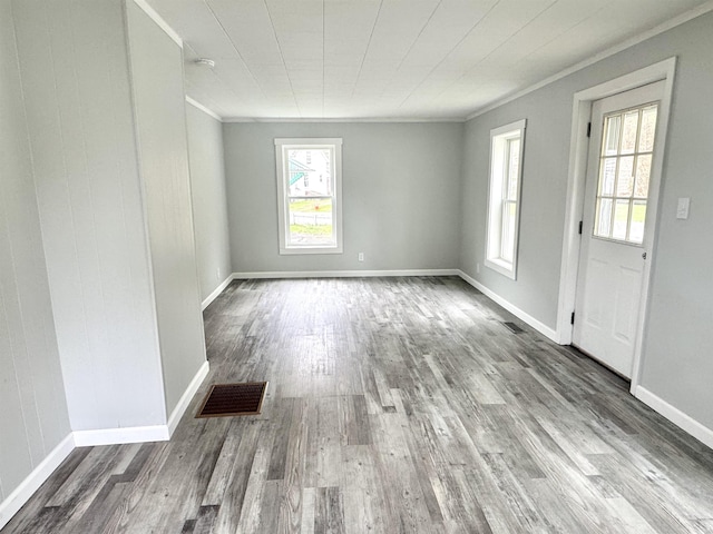 217 Clyde St, Newport City, VT 05855 - spare room featuring ornamental molding, plenty of natural light, wood finished floors, and baseboards