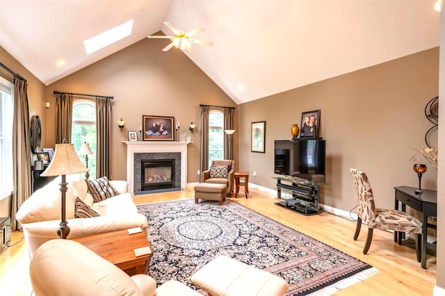 16 Gilboa Ln, Nashua, NH 03062 - living area with a skylight, high vaulted ceiling, ceiling fan, wood finished floors, and a fireplace
