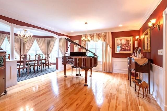 16 Gilboa Ln, Nashua, NH 03062 - living area with a chandelier, healthy amount of natural light, light wood finished floors, crown molding, and a wainscoted wall