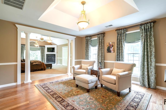 16 Gilboa Ln, Nashua, NH 03062 - living area with ornate columns, a tray ceiling, wood finished floors, and baseboards