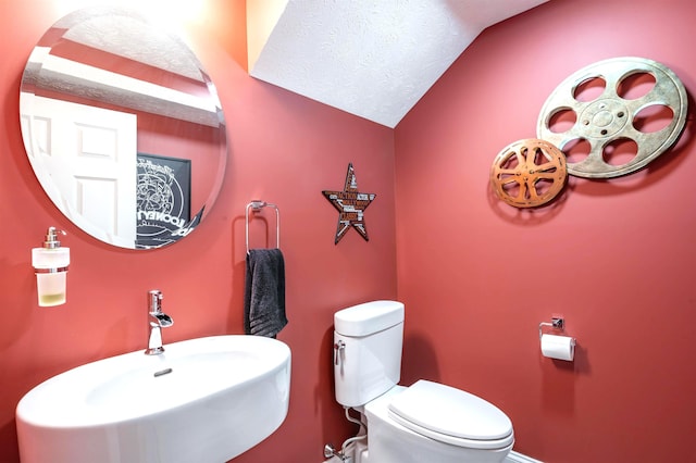 16 Gilboa Ln, Nashua, NH 03062 - half bath with a sink, toilet, and lofted ceiling
