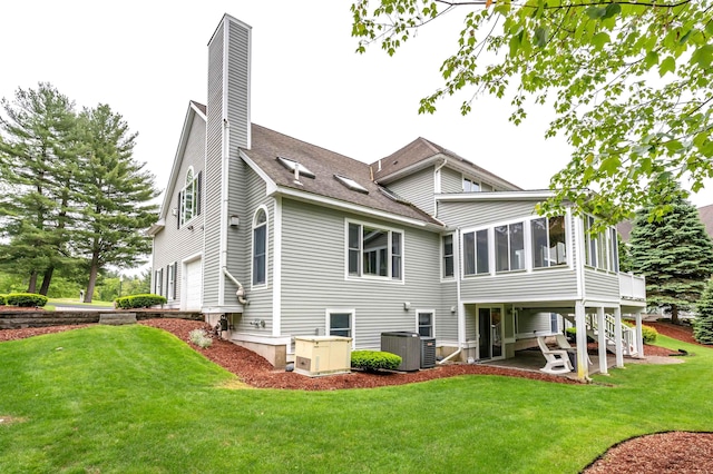 16 Gilboa Ln, Nashua, NH 03062 - back of property with a sunroom, a yard, a chimney, and a patio