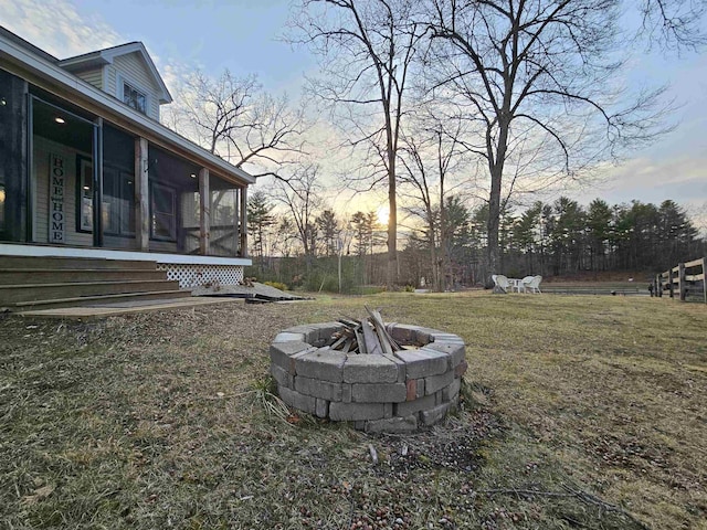 436 Mammoth Rd, Pelham, NH 03076 - yard at dusk with a fire pit, a sunroom, and a yard