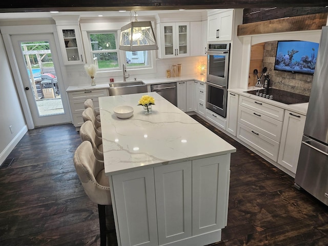 436 Mammoth Rd, Pelham, NH 03076 - kitchen with a sink, appliances with stainless steel finishes, a kitchen island, tasteful backsplash, and dark wood-style flooring