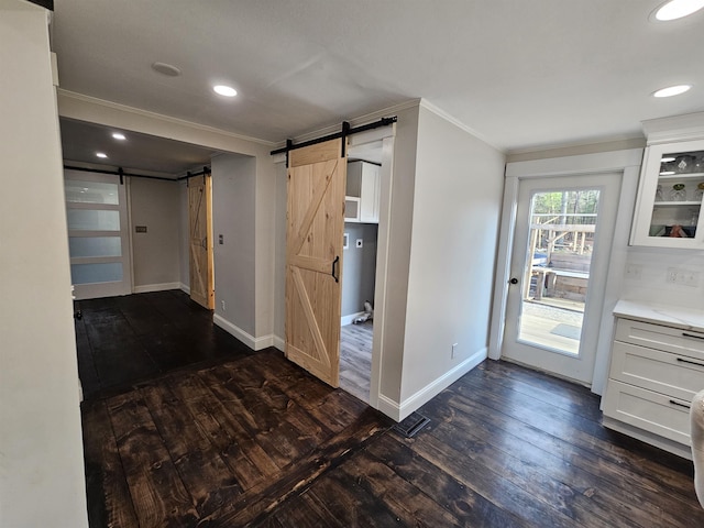436 Mammoth Rd, Pelham, NH 03076 - kitchen with a barn door, crown molding, dark wood-style flooring, white cabinetry, and baseboards