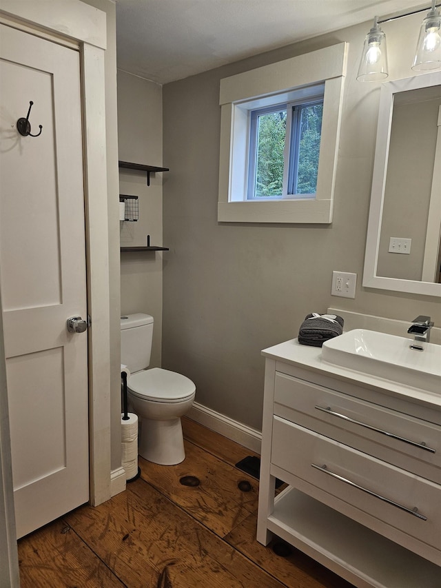 436 Mammoth Rd, Pelham, NH 03076 - half bath featuring vanity, toilet, wood finished floors, and baseboards